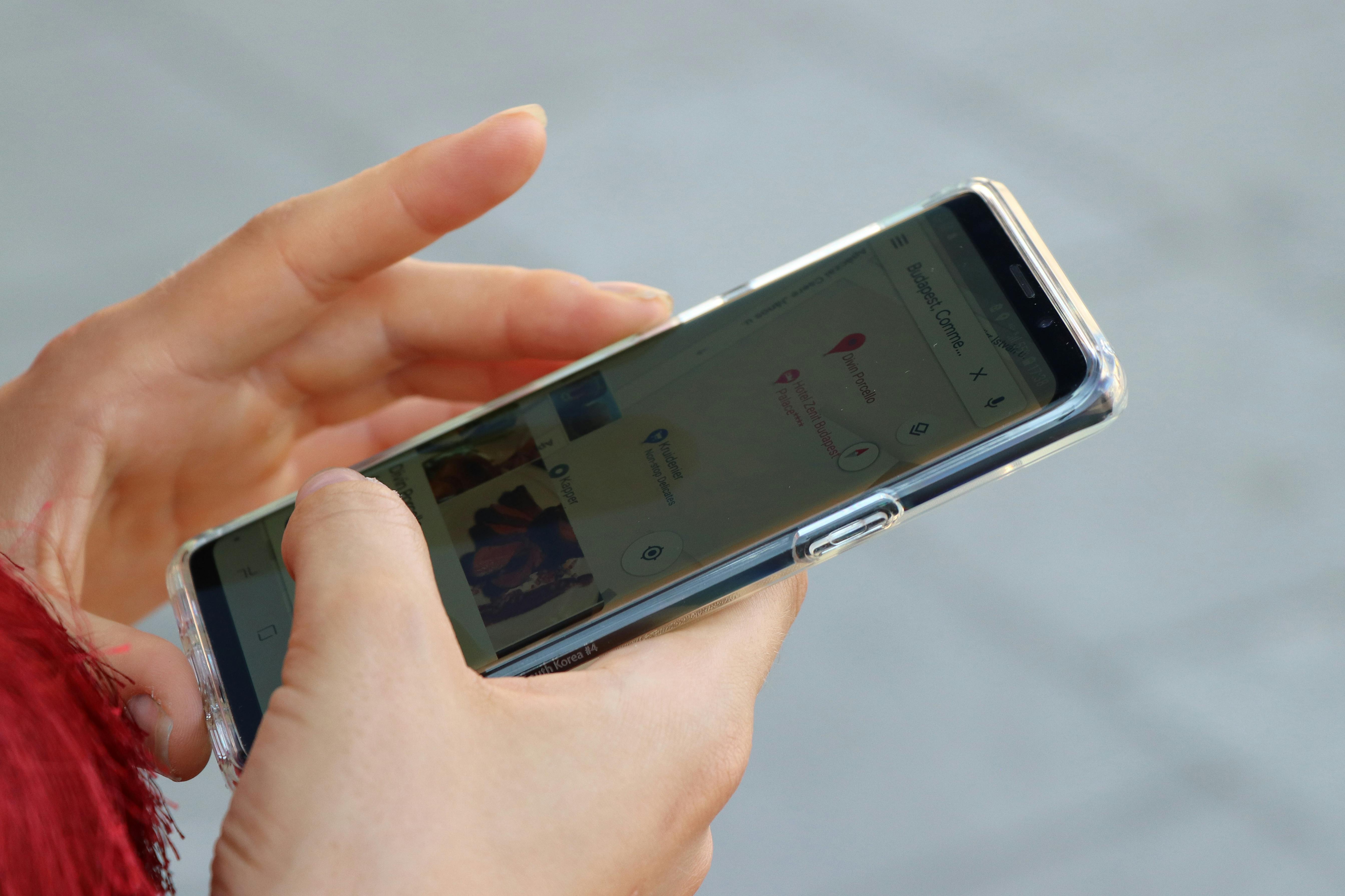 close up of hands typing on a mobile smart phone