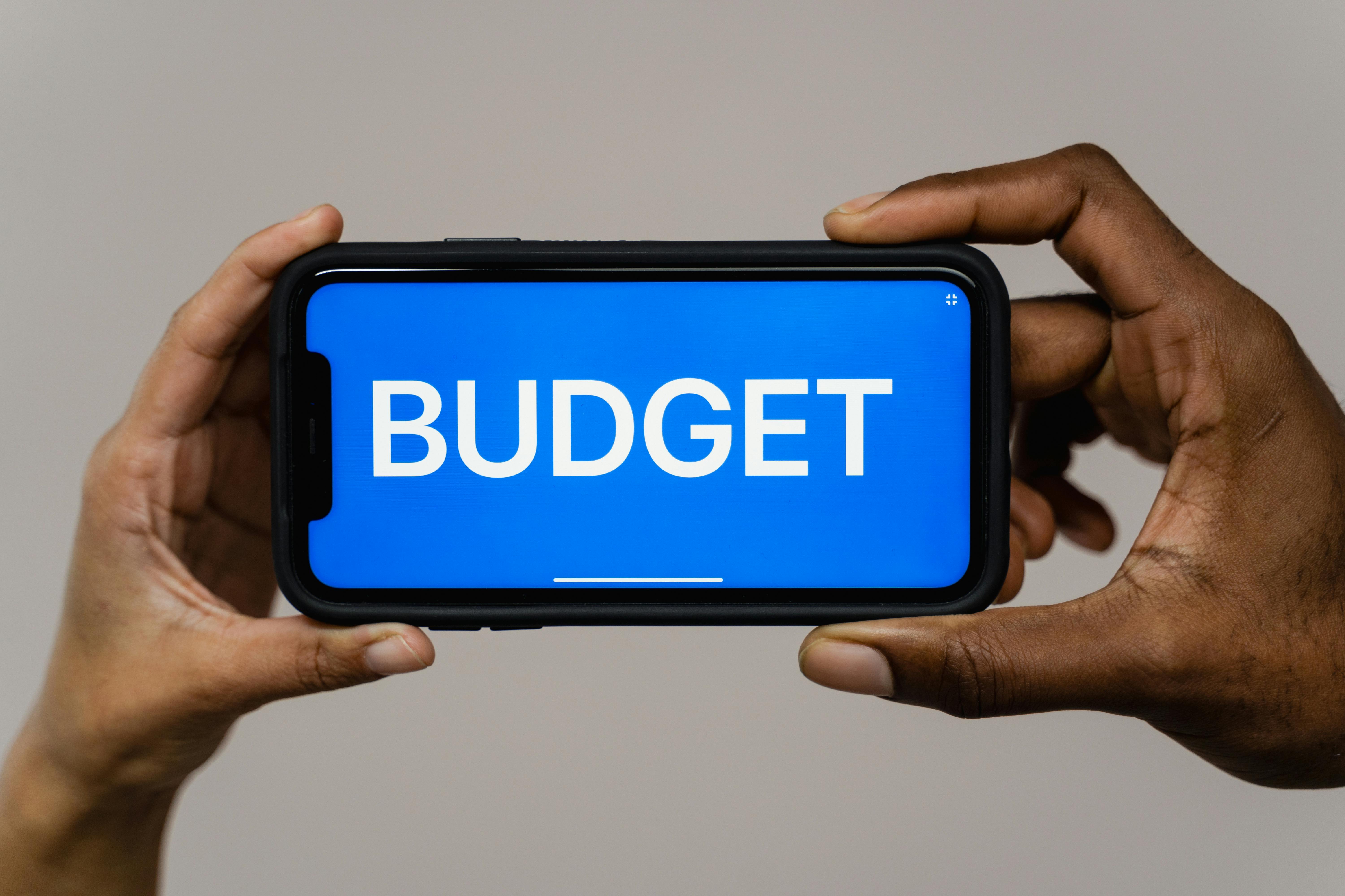 landscape mobile phone with words BUDGET in blue on screen