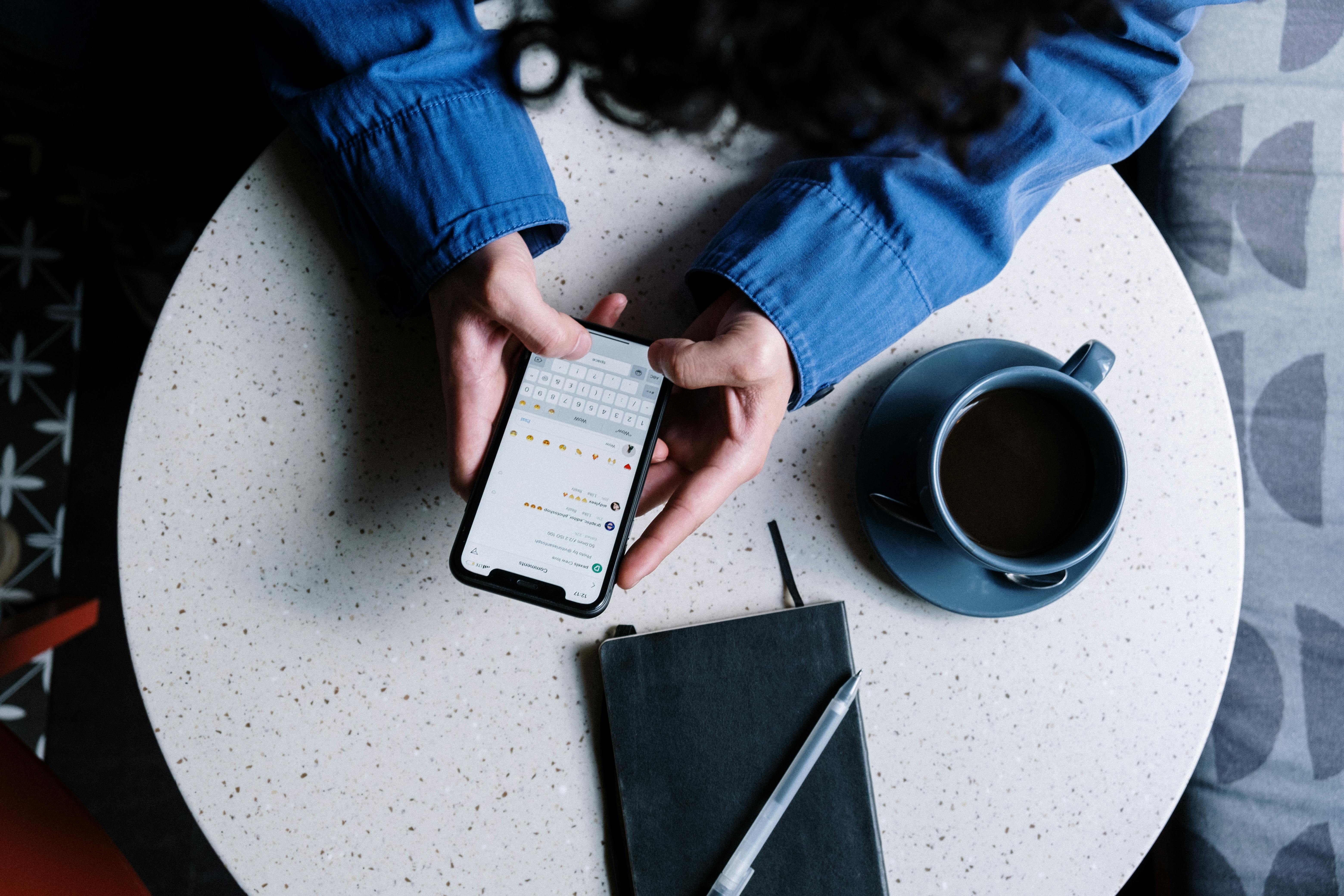 person on mobile phone in a cafe