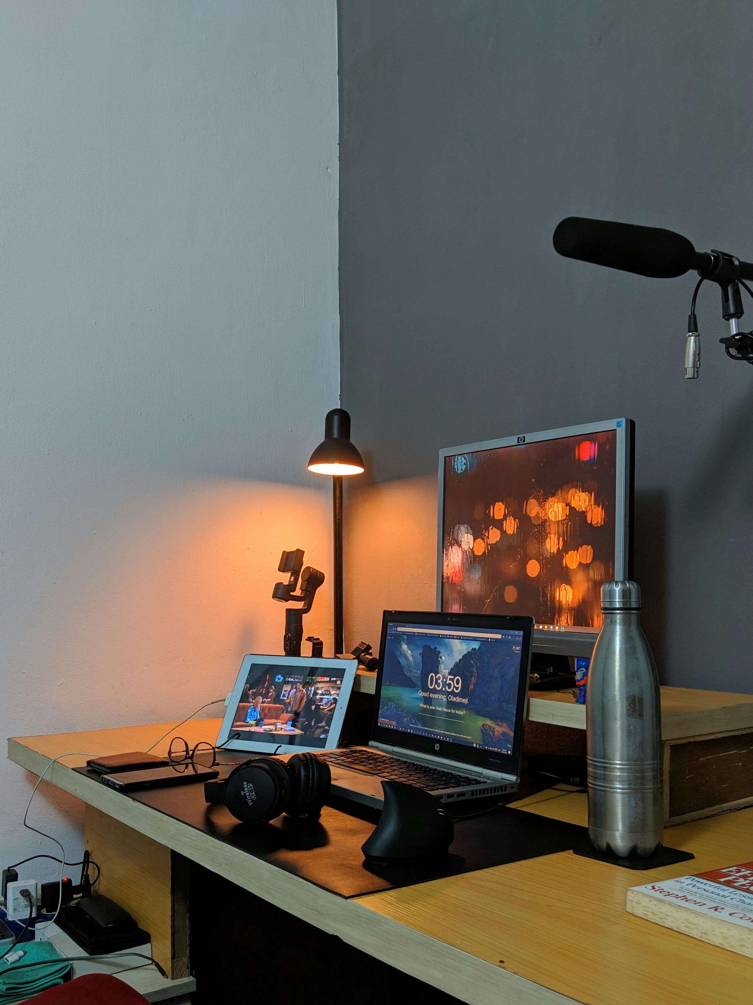 home office desk setting with mobile, tablet, laptop and monitor