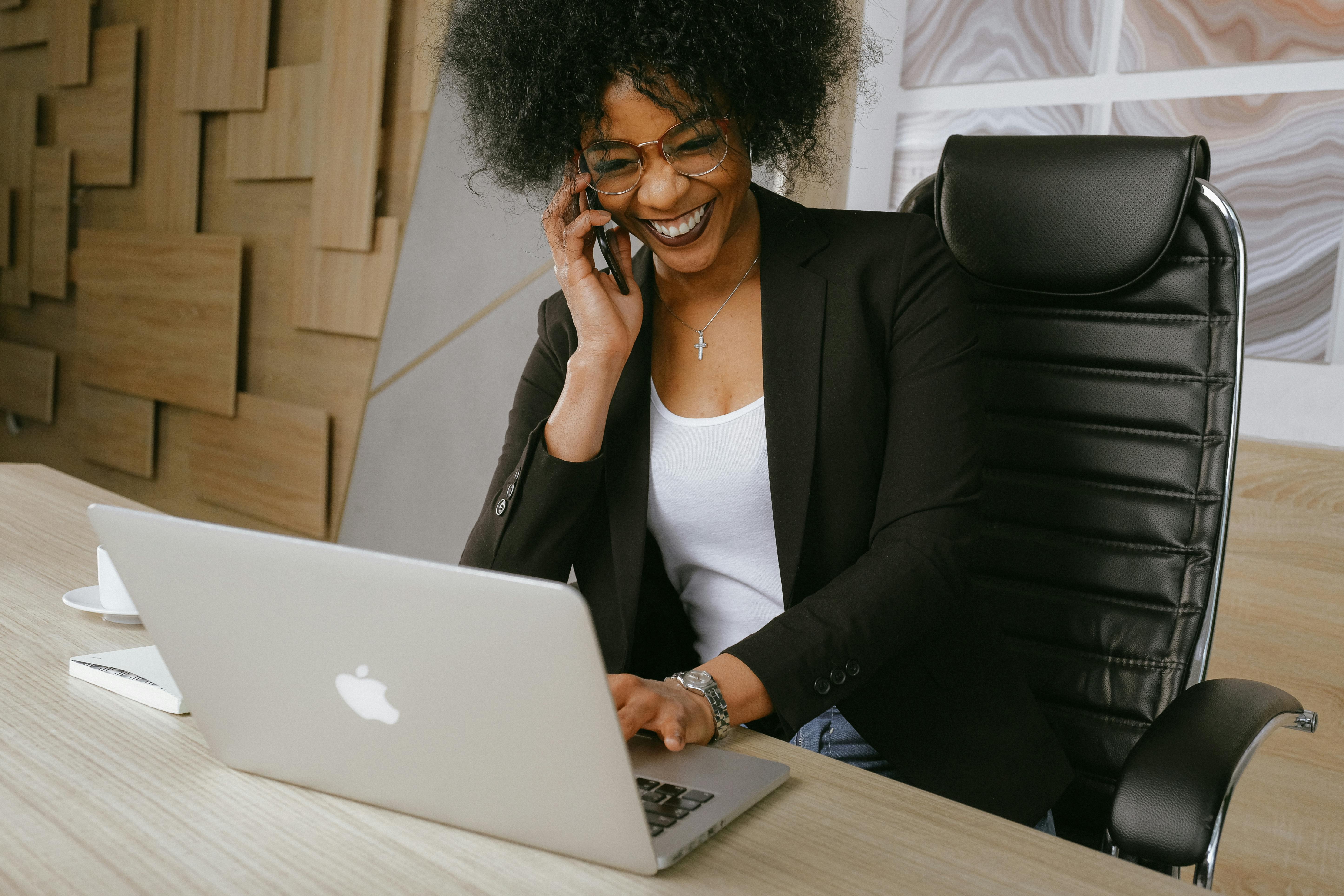 woman on mobile phone behind desk in office setting