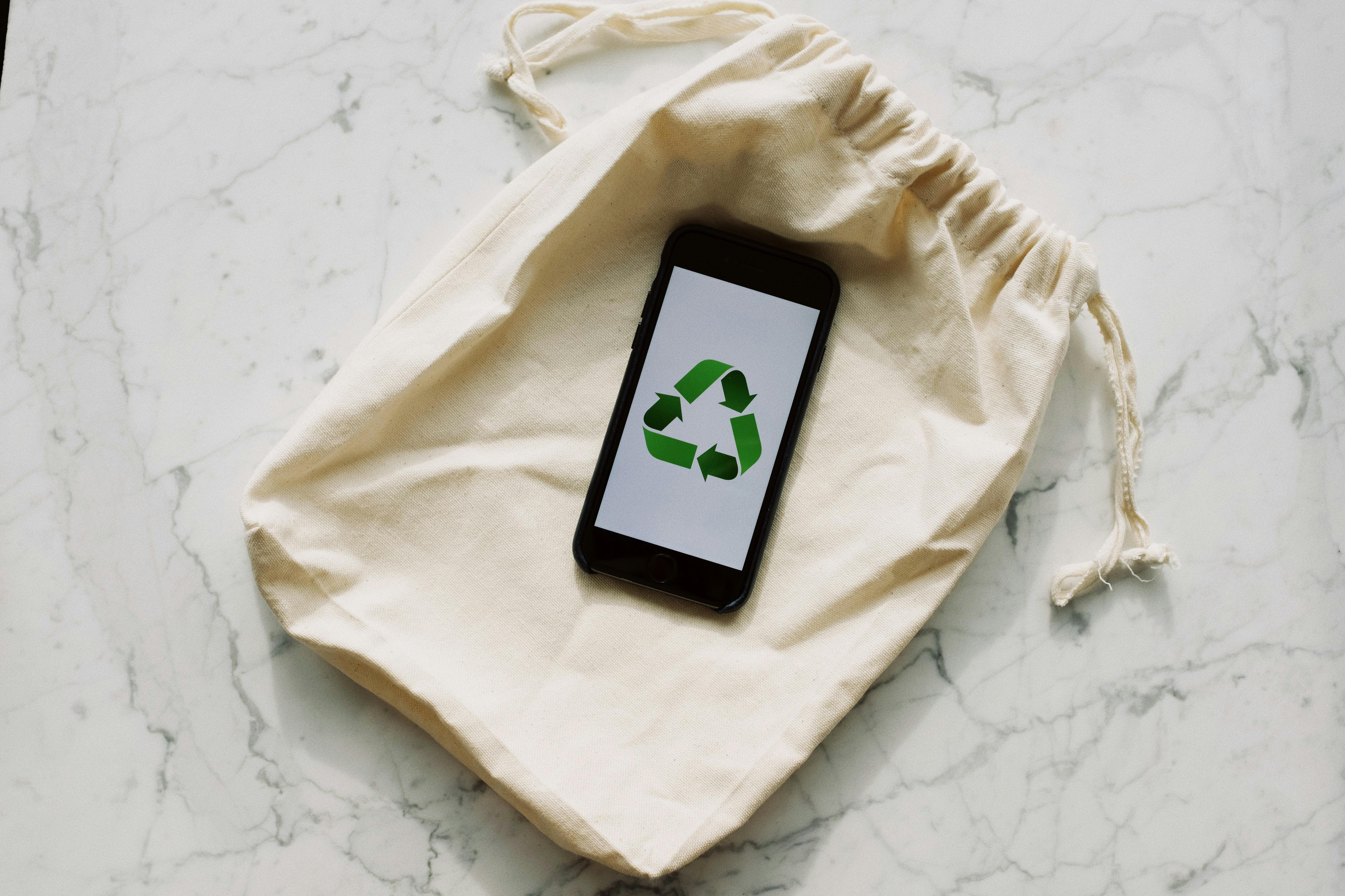 smart phone with image of recycling on screen